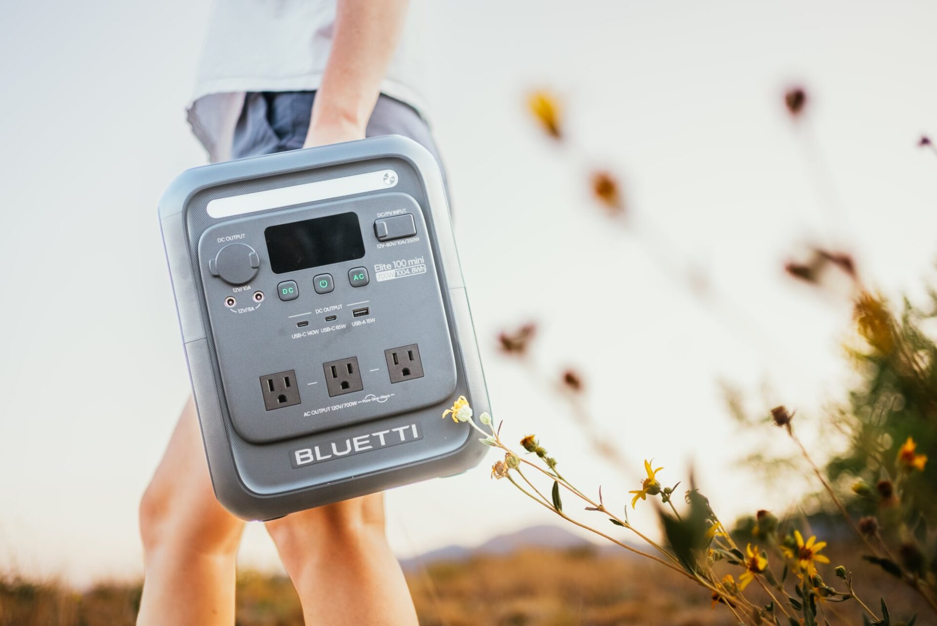 a person carries the Bluetti Elite 100 mini portable power station